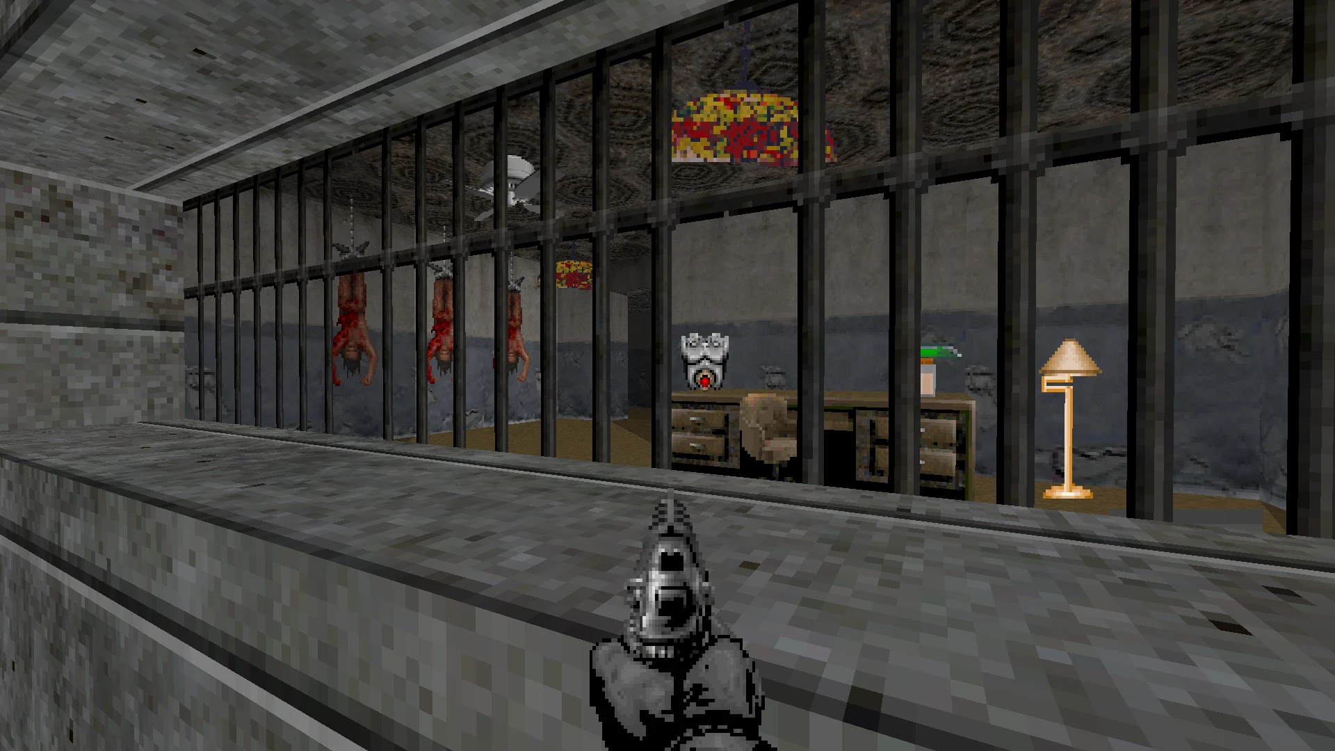 First-person view of a barred torture room with hanging bodies and a desk inside in Robocop Doom mod