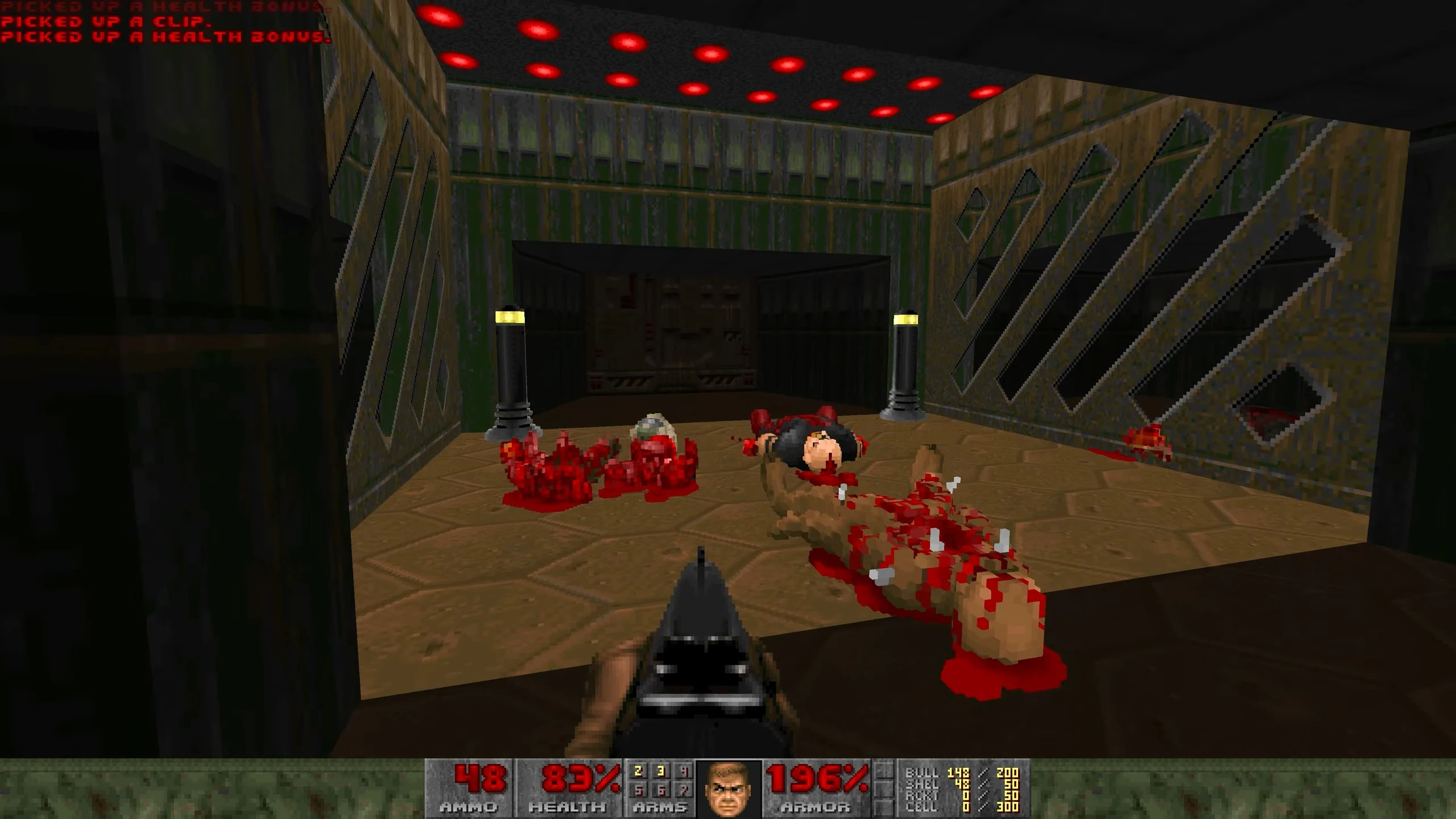 Screenshot of classic Doom with Voxel Doom mod displaying pixelated gore and player armed with shotgun in corridor