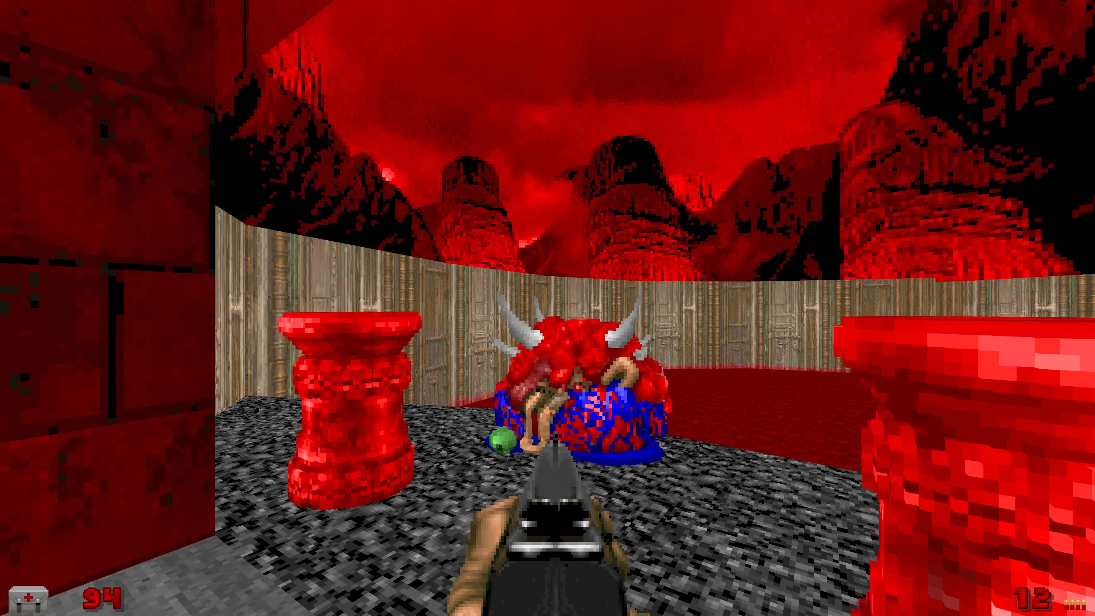 First-person view in Doom mod Voxel Doom showing a red horned pixelated demon and red pillars