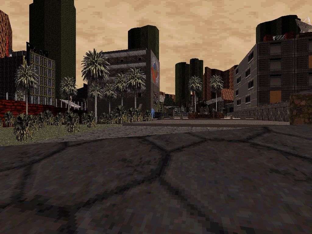 Captura del mod Blast Radius de Duke Nukem 3D con edificios pixelados, palmeras y pavimento agrietado