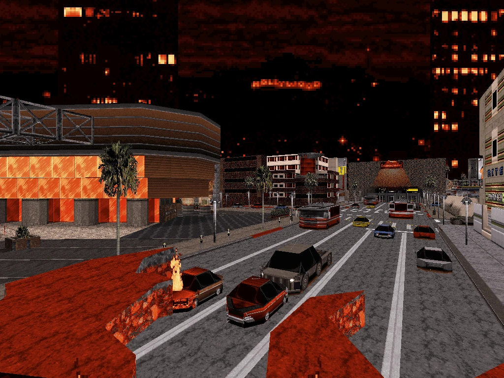 Captura de pantalla del mod Duke Nukem 3D Blast Radius con calle urbana dañada, coche en llamas y paisaje urbano nocturno