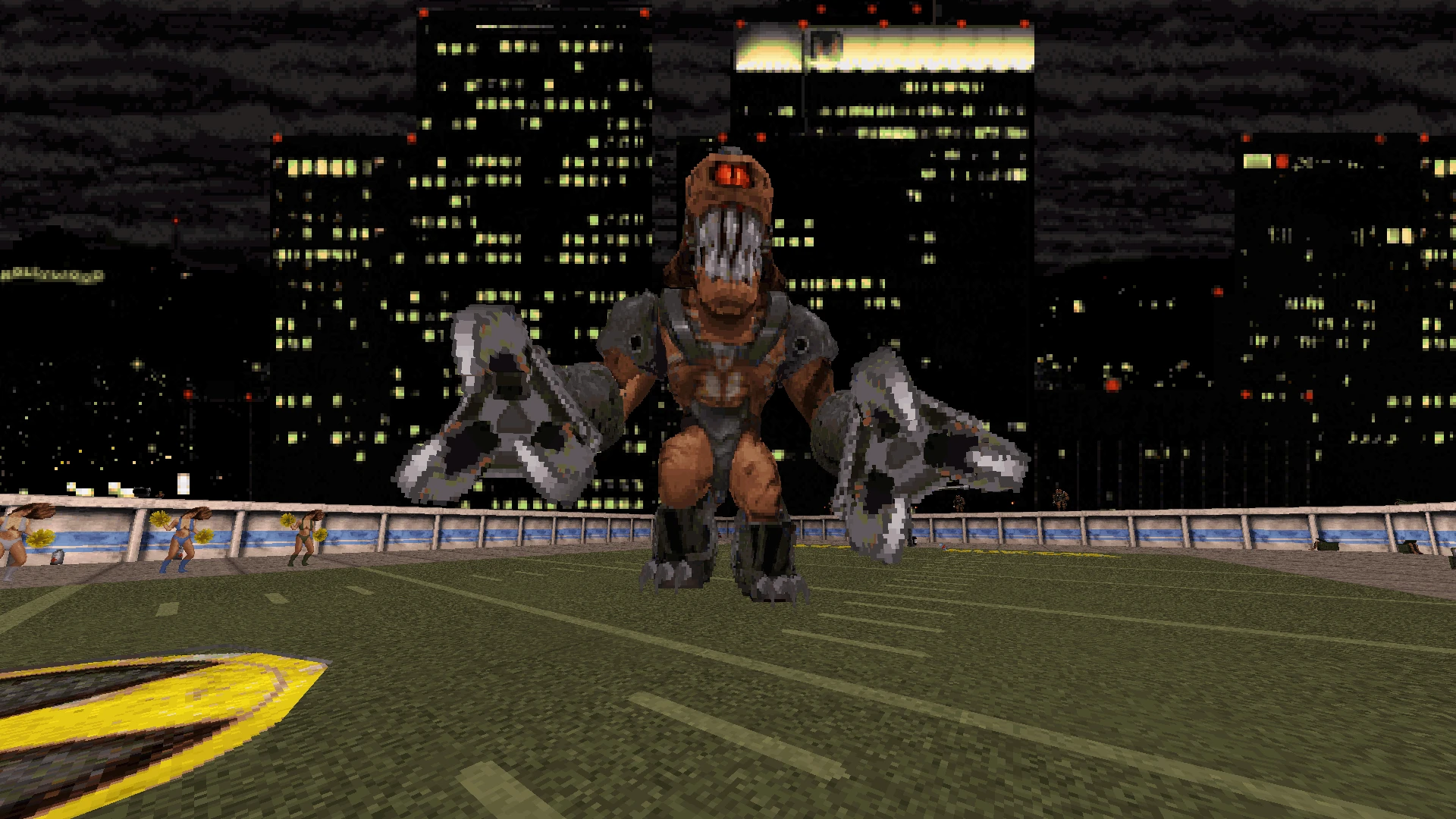 Screenshot des Voxel Duke Nukem 3D Mods mit großem Monster-Boss auf einem Dach-Fußballfeld bei Nacht mit Stadtsilhouette