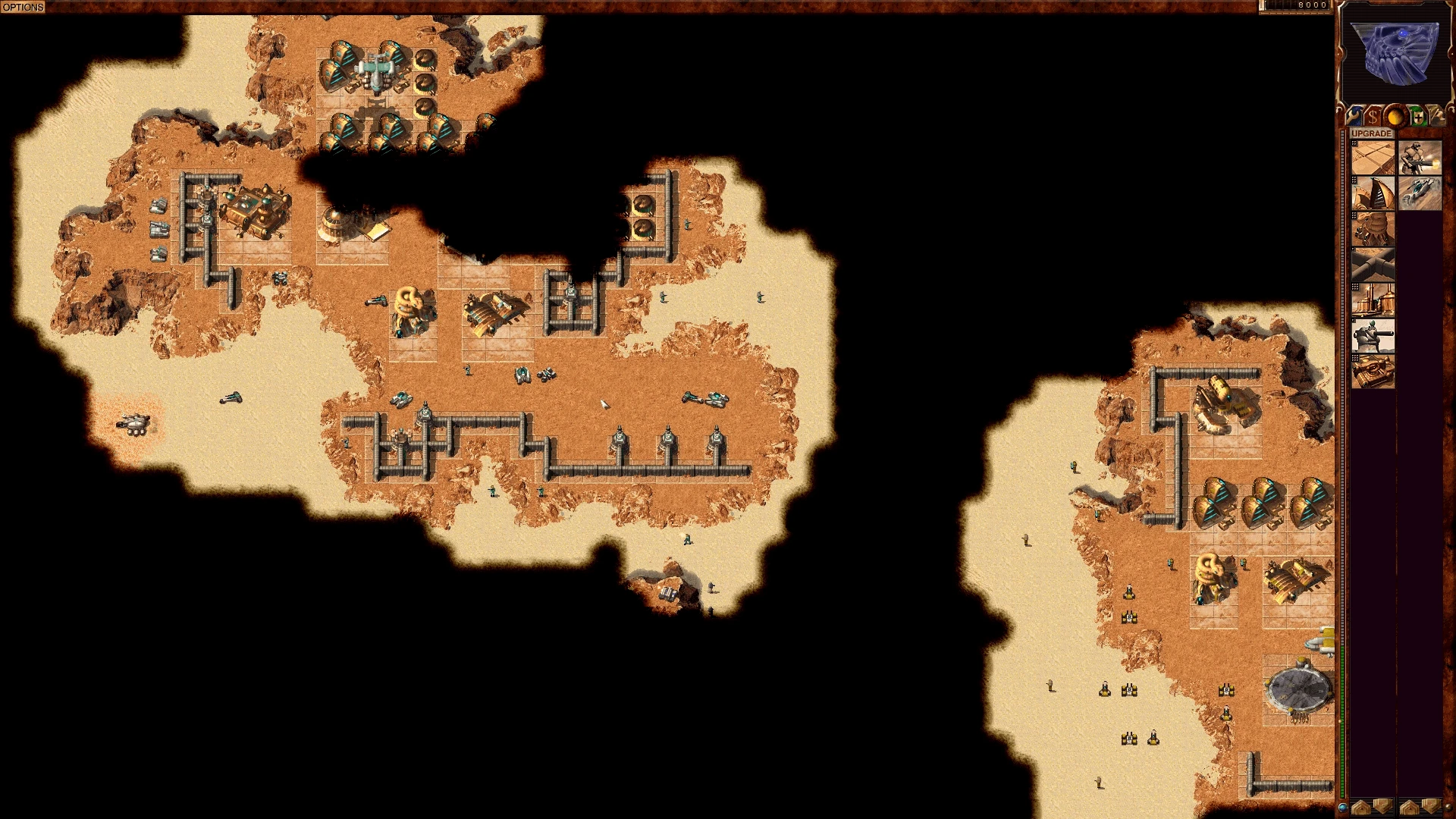 Draufsicht auf eine Wüstenbasis mit Mauern, Türmen, Gebäuden und Einheiten in Dune 2000 GruntMods Edition