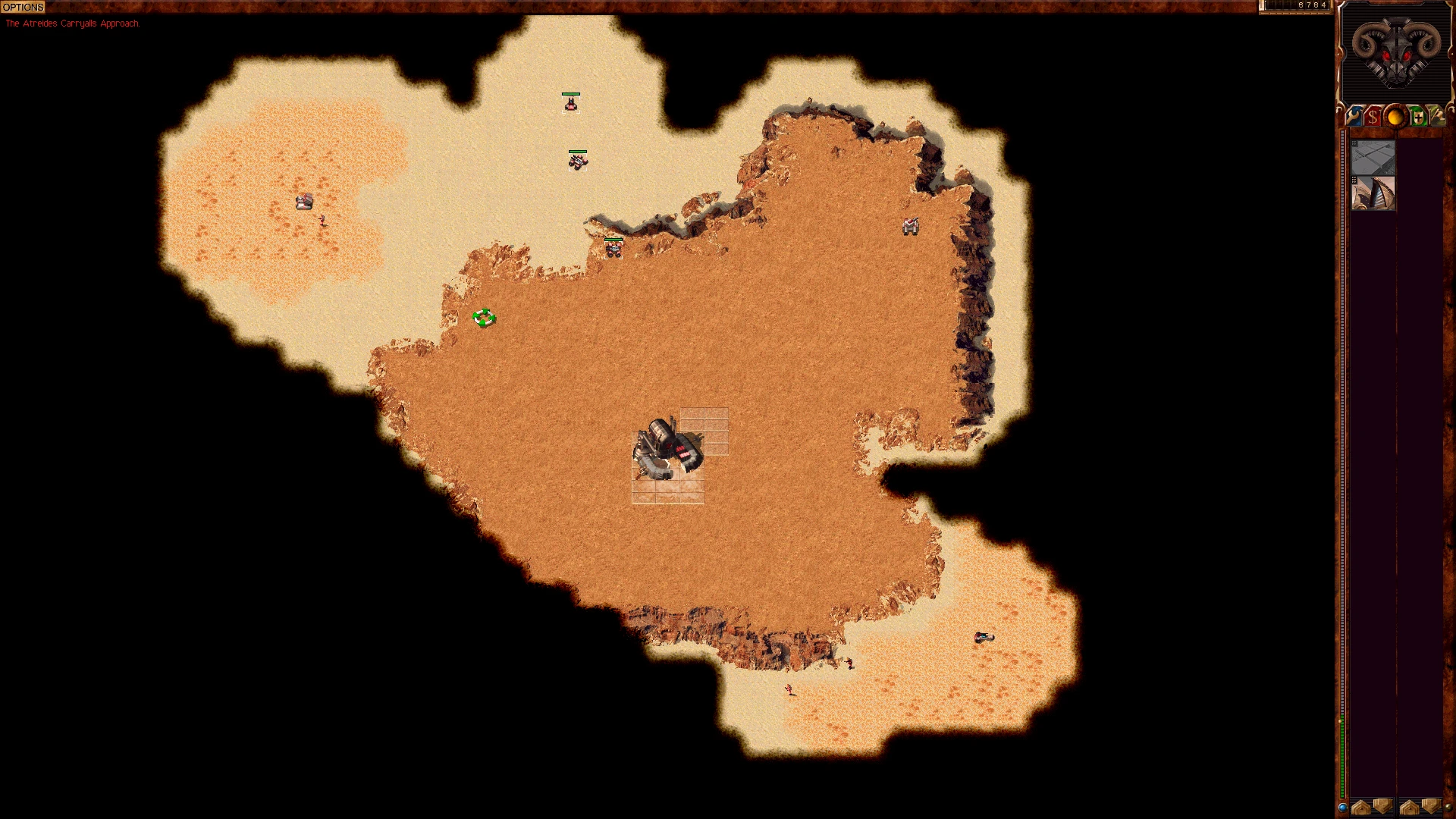 Draufsicht auf eine Wüstenbasis mit verstreuten Einheiten und felsigem Gelände im Dune 2000 Mod