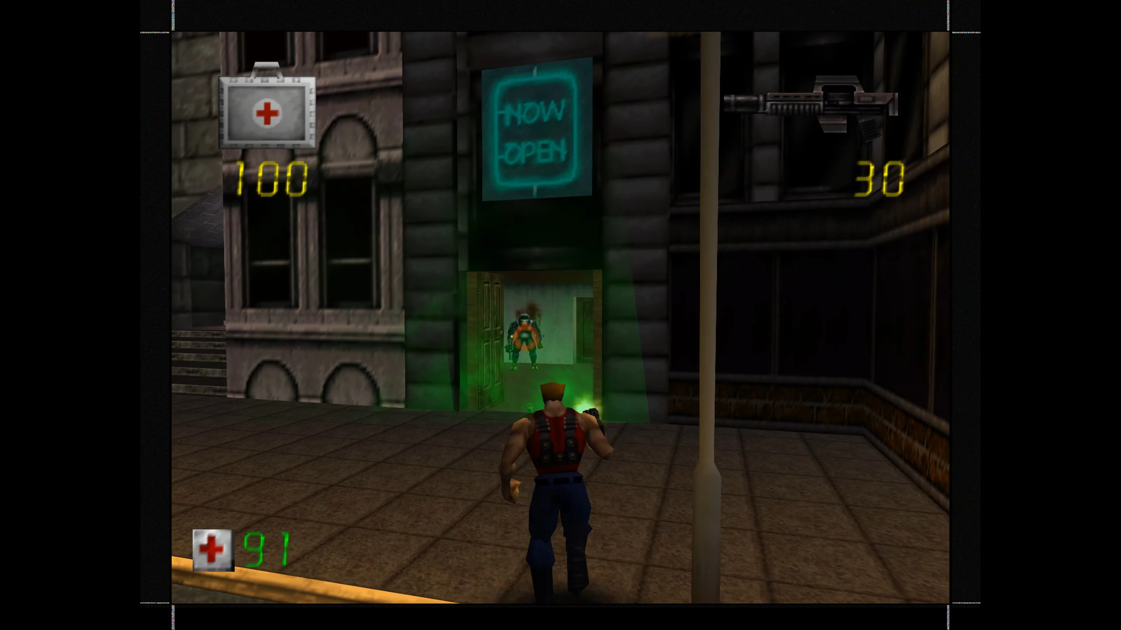 Duke Nukem Charakter zielt auf bewaffneten Feind in einem Gebäude mit Lebens- und Munitionsanzeige