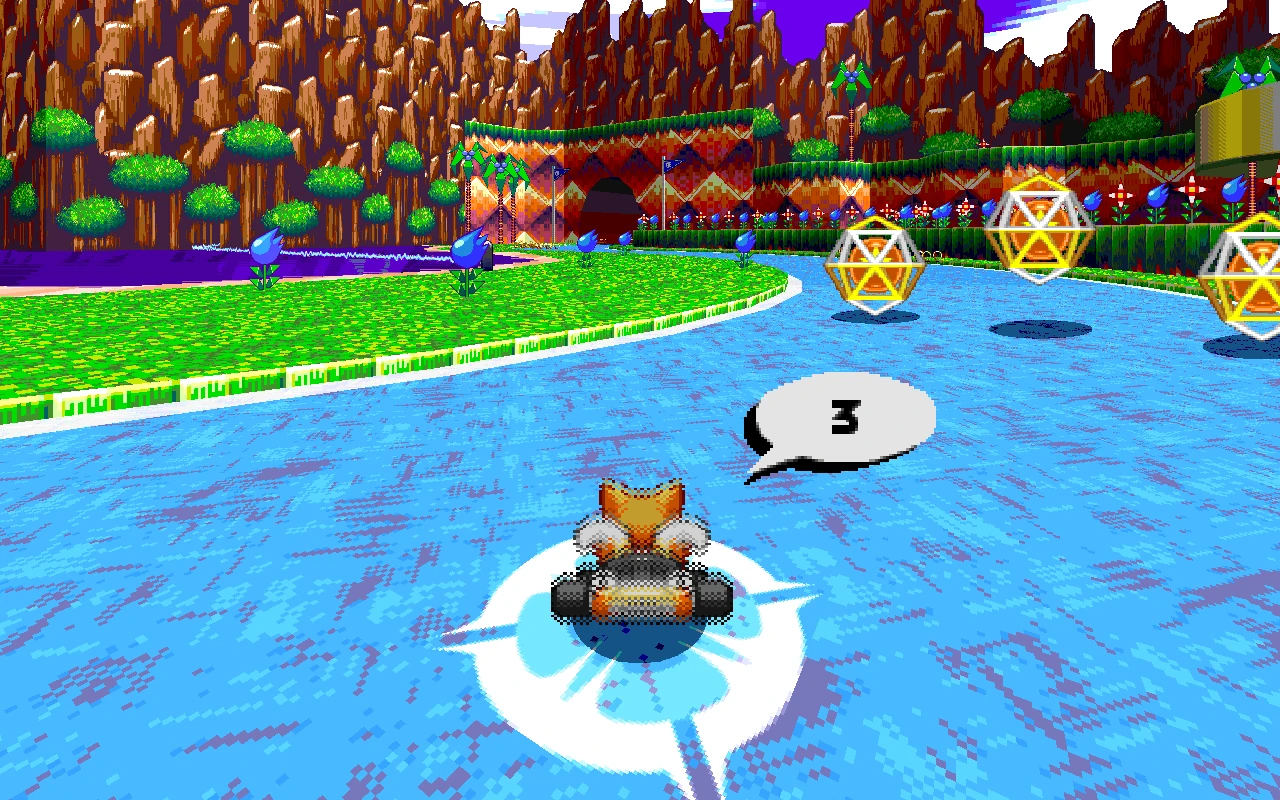 Tails prowadzi kart na niebieskim torze otoczonym zielonymi wzgórzami i unoszącymi się pierścieniami w Sonic Robo Blast