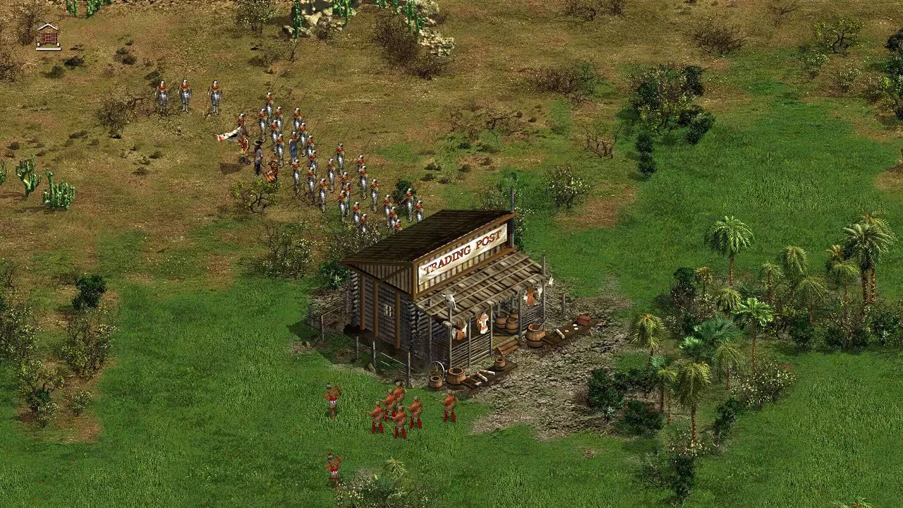 Draufsicht auf Soldaten in Formation neben einem hölzernen Handelsposten-Gebäude in der Landschaft von American Conquest Fight Back