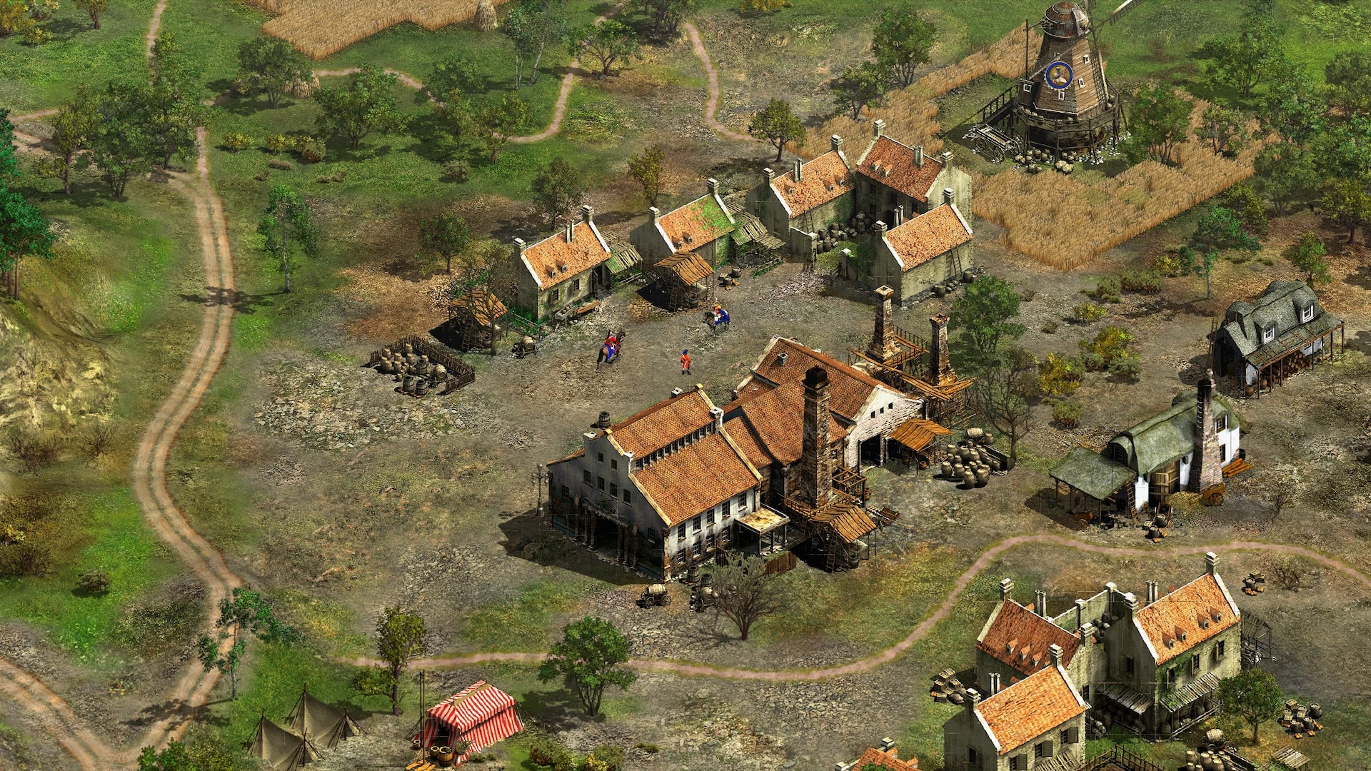 Draufsicht auf ein Dorf in Cossacks II mit detaillierten Häusern, einer Windmühle und berittenen Soldaten