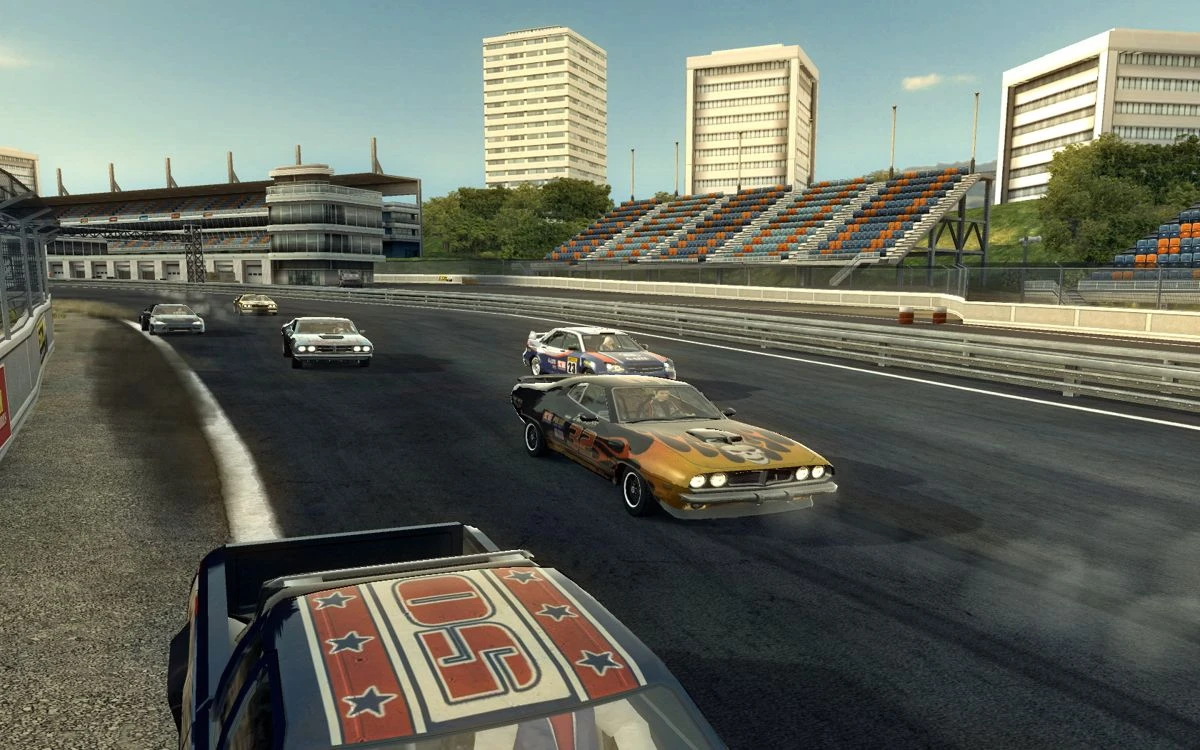 FlatOut 2 screenshot: a group of muscle cars racing on a stadium asphalt track
