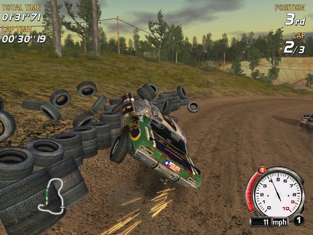 FlatOut screenshot: a racing car crashes into a stack of tires on a dirt road