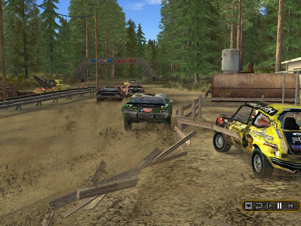 FlatOut screenshot: group of cars racing and colliding on a dirt road through a dense forest
