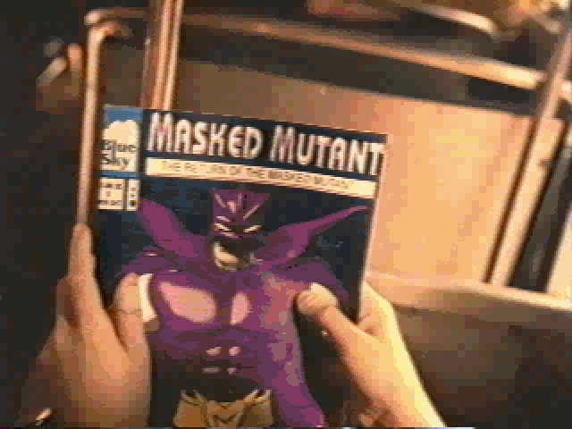 Hands holding a Masked Mutant comic book with a purple character on the cover