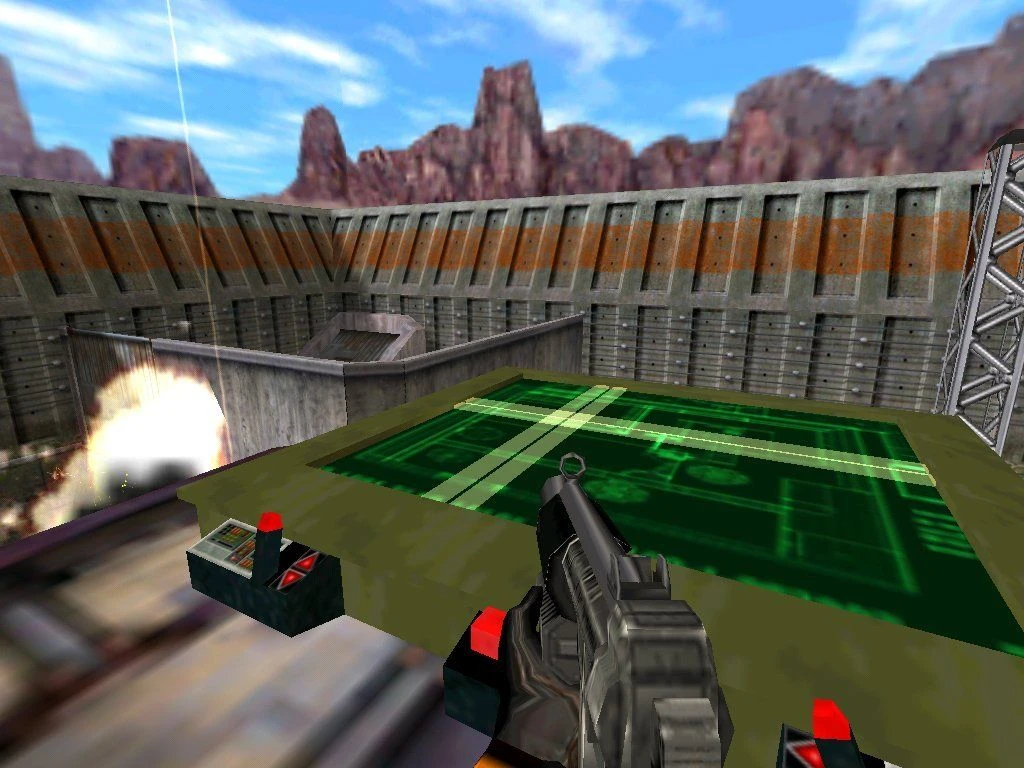 Screenshot from Half-Life (1998): player aiming from control desk while an explosion occurs nearby on the outdoor base
