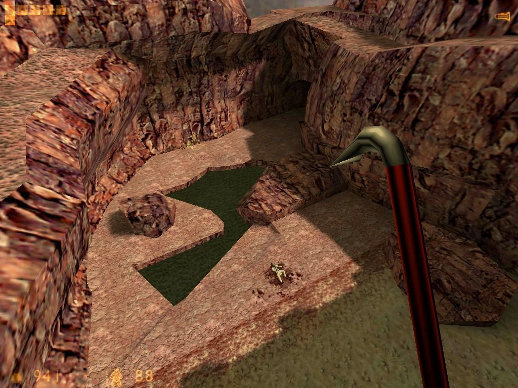 Screenshot from Half-Life (1998): player with crowbar stands above a canyon with green toxic water and a body below