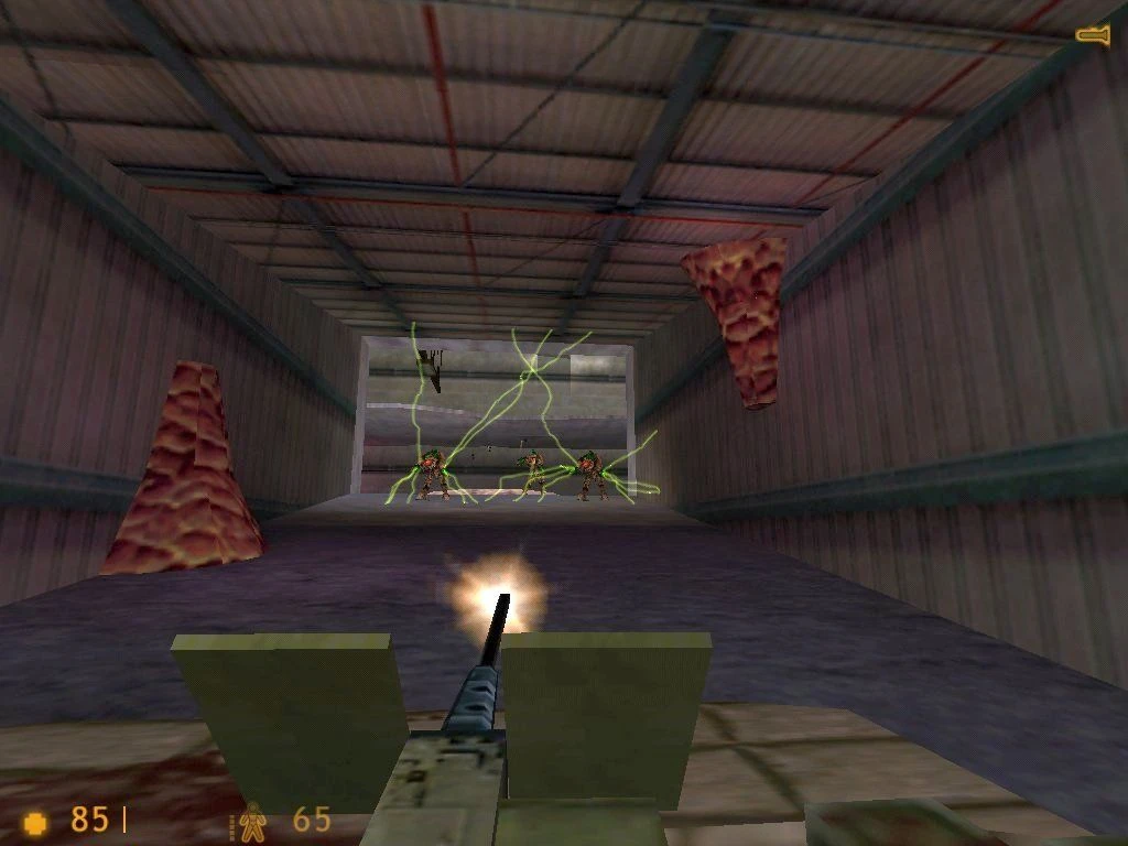 Screenshot from Half-Life (1998): player firing mounted turret at alien enemies inside a warehouse tunnel