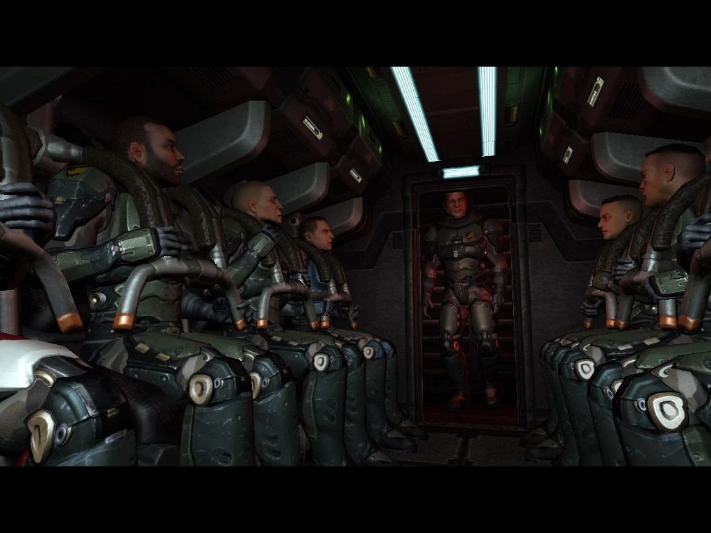 Grupo de soldados con armadura futurista sentados dentro de un vehículo de transporte blindado con poca luz de Quake 4