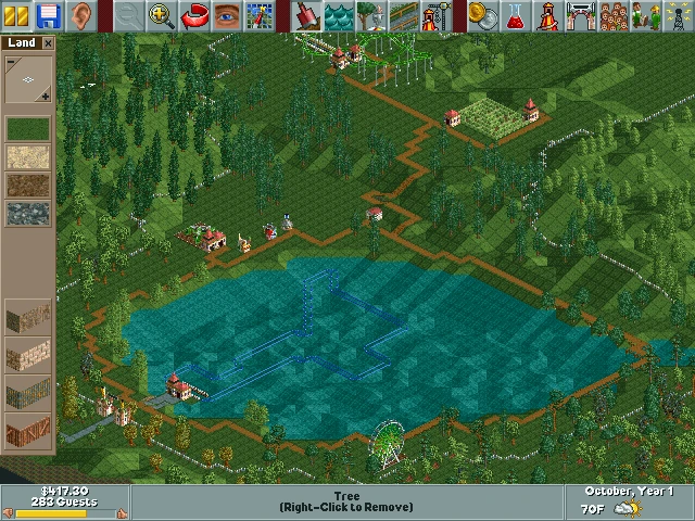 Zrzut ekranu RollerCoaster Tycoon 1999 z jeziorem i planowaną atrakcją wodną oraz ścieżkami i drzewami wokół parku