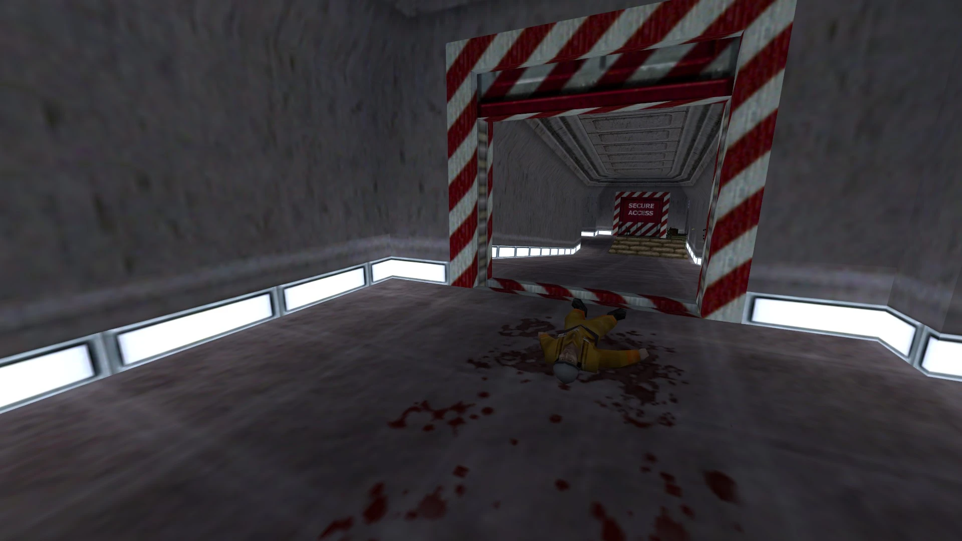 Escena del juego que muestra a un trabajador de materiales peligrosos muerto en el suelo cerca de una puerta de acceso seguro en una instalación industrial en Half-Life 1998