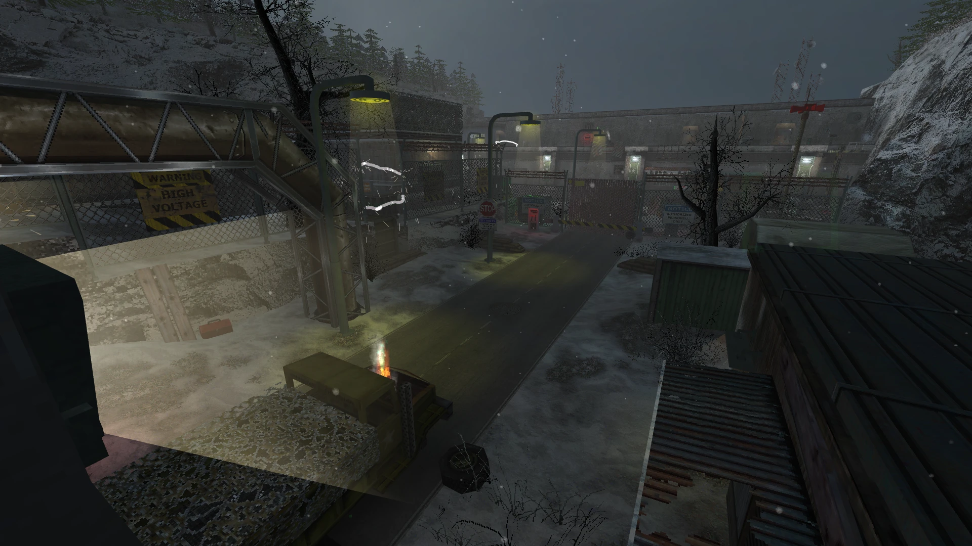 Snow-covered military base entrance with fences, lamps, and high voltage sign in Half-Life Deep Cover mod