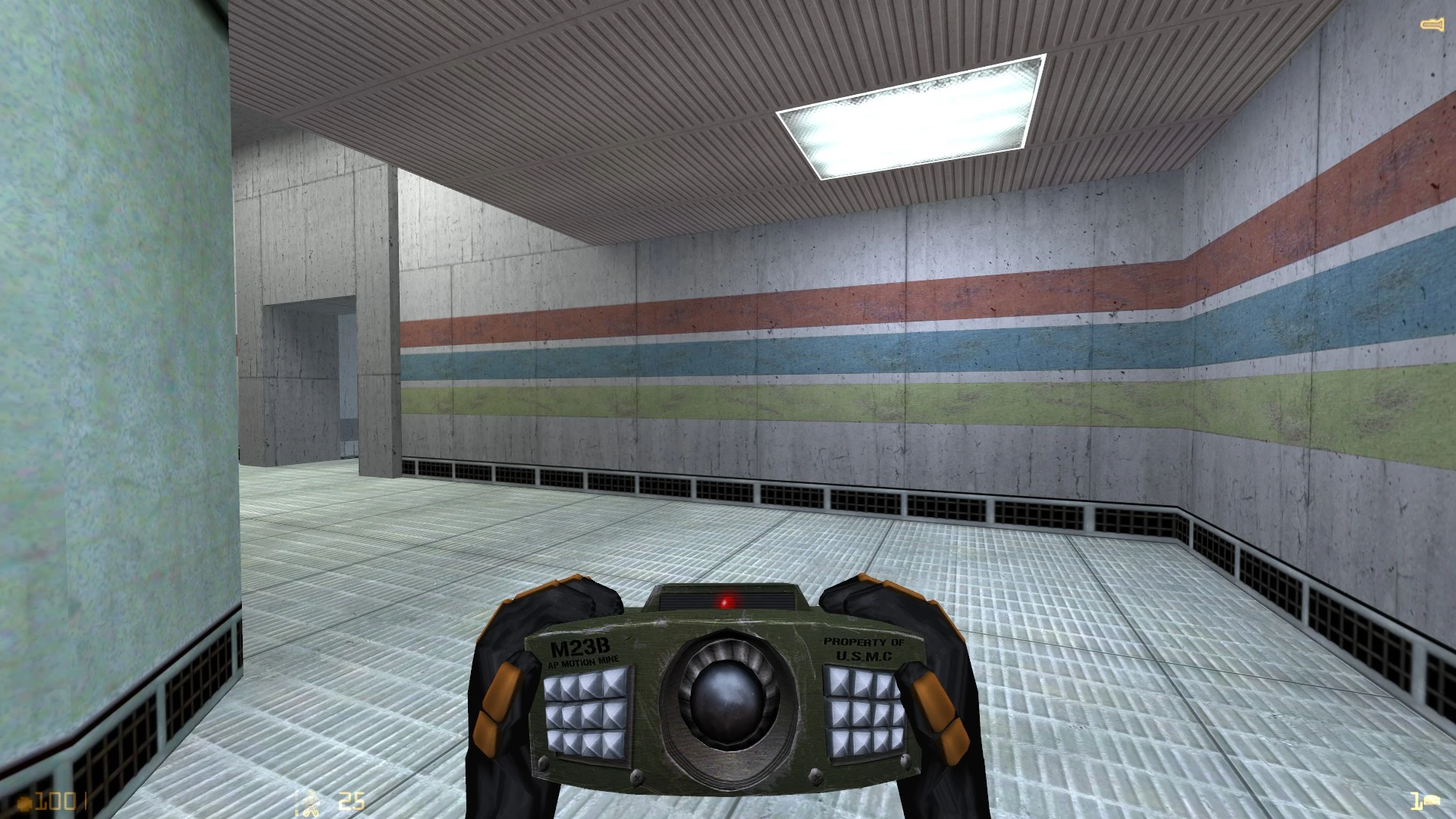 First-person view holding an M23B AP motion mine in a brightly lit industrial corridor
