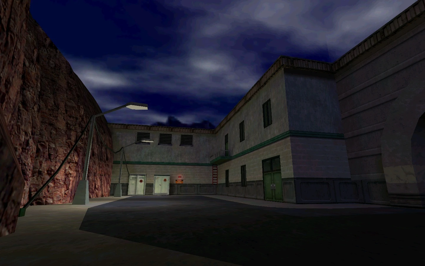 Escena nocturna en el mod Half-Life Field Intensity con edificios industriales y farolas