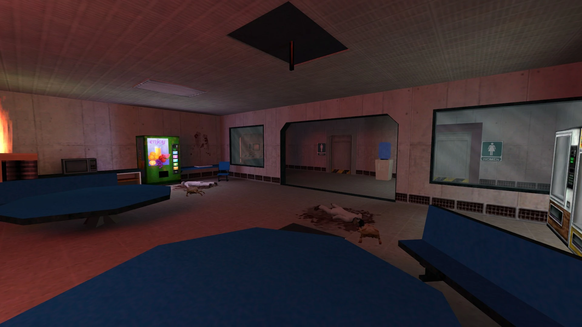 Интерьер комнаты с торговыми автоматами, синими скамейками, трупами, пятнами крови и огнем у стены