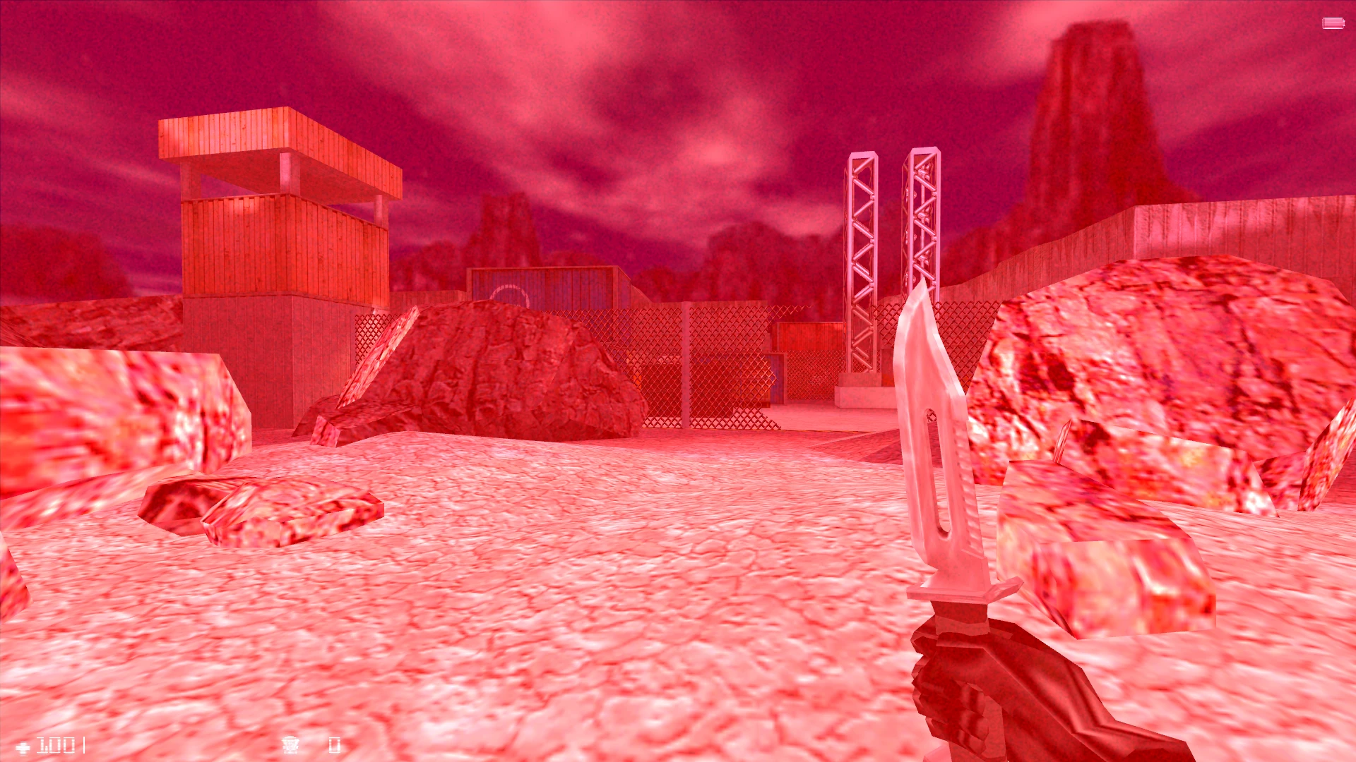 Vista en primera persona en mod de Half-Life mostrando personaje con cuchillo en área rocosa al aire libre con torre de vigilancia