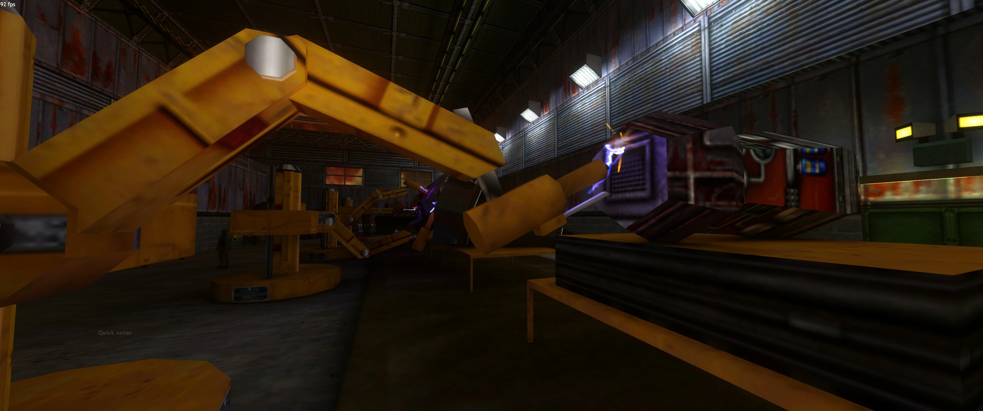 Interior de almacén con poca luz mostrando varios brazos robóticos amarillos y equipo industrial en mod de Half-Life