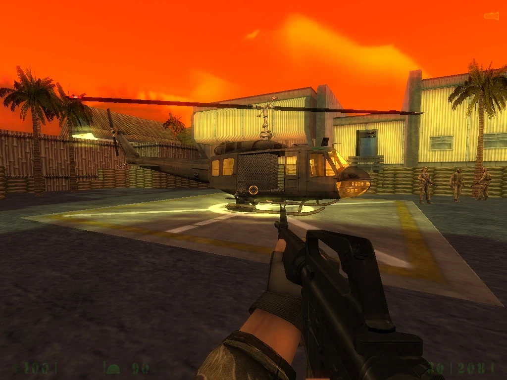 First-person view of a soldier aiming at a helicopter on a military base at sunset in the Heart Of Evil Napalm Edition mod