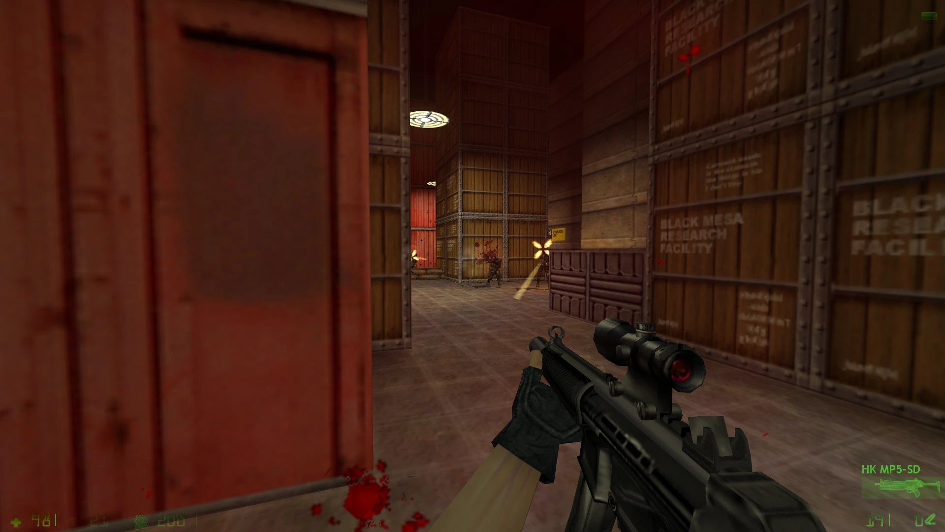 First-person view of player shooting at enemies inside a storage area with wooden crates in Half-Life Opposing Force Enlightened mod