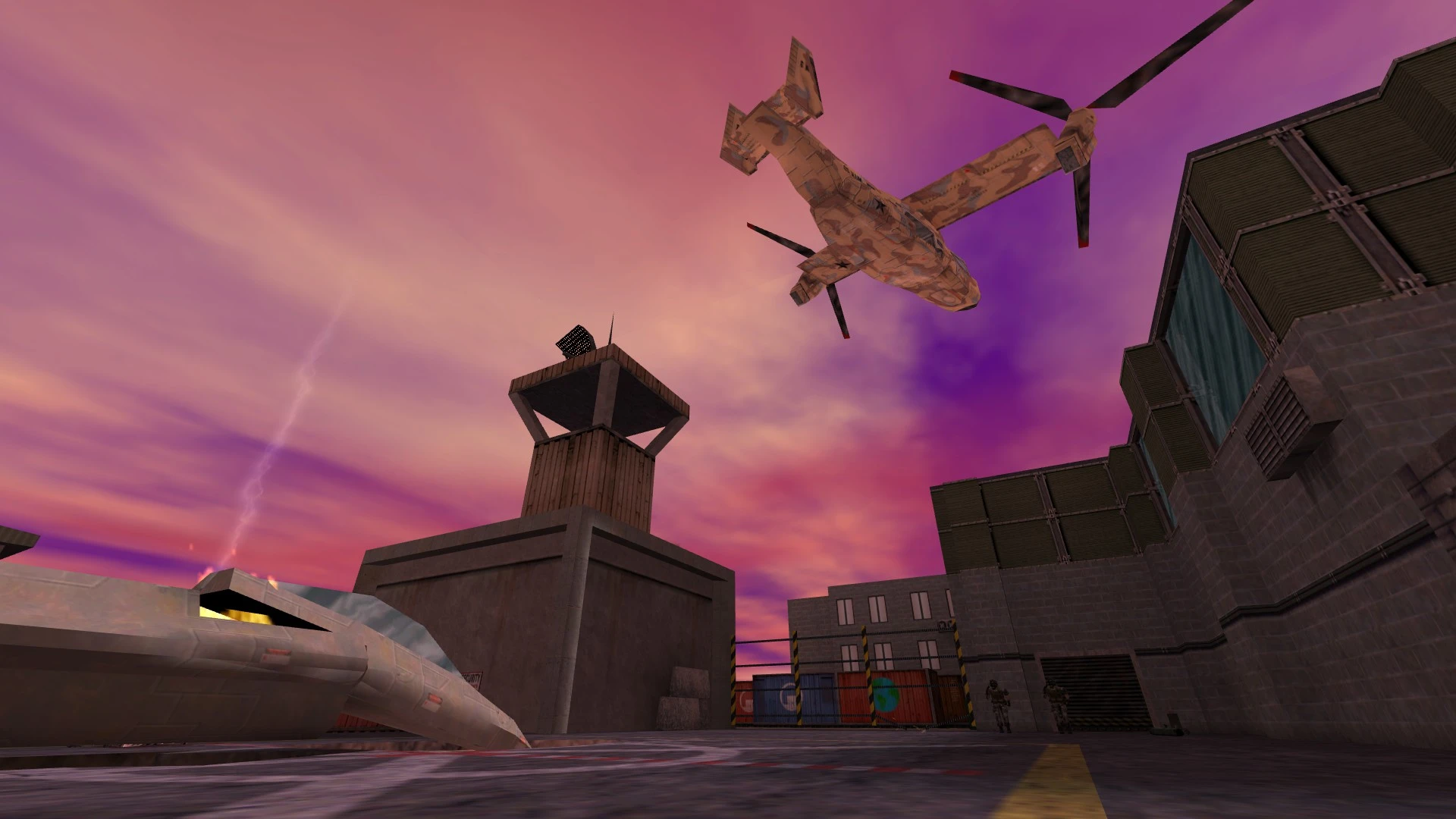 Widok w grze na helikopter lecący nad strefą przemysłową z wieżą obserwacyjną i kontenerami w modzie Half-Life Reprocessing