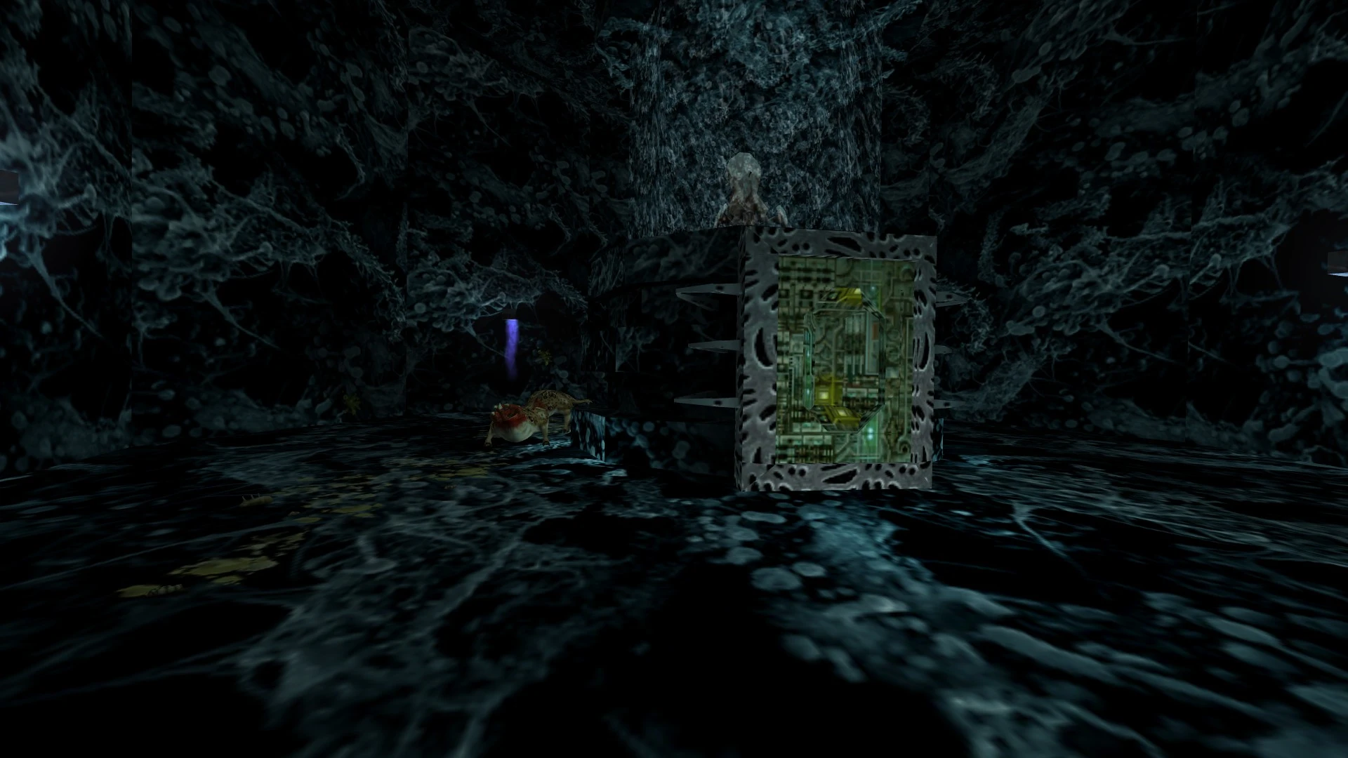 In-game screenshot showing a dark cave filled with alien web-like textures and a glowing panel on a cube