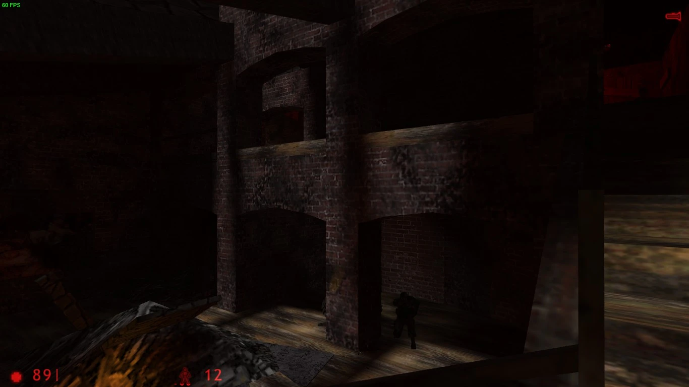 Captura de pantalla del interior oscuro de un edificio de ladrillo con una pequeña figura armada y luz tenue en el mod They Hunger Relit
