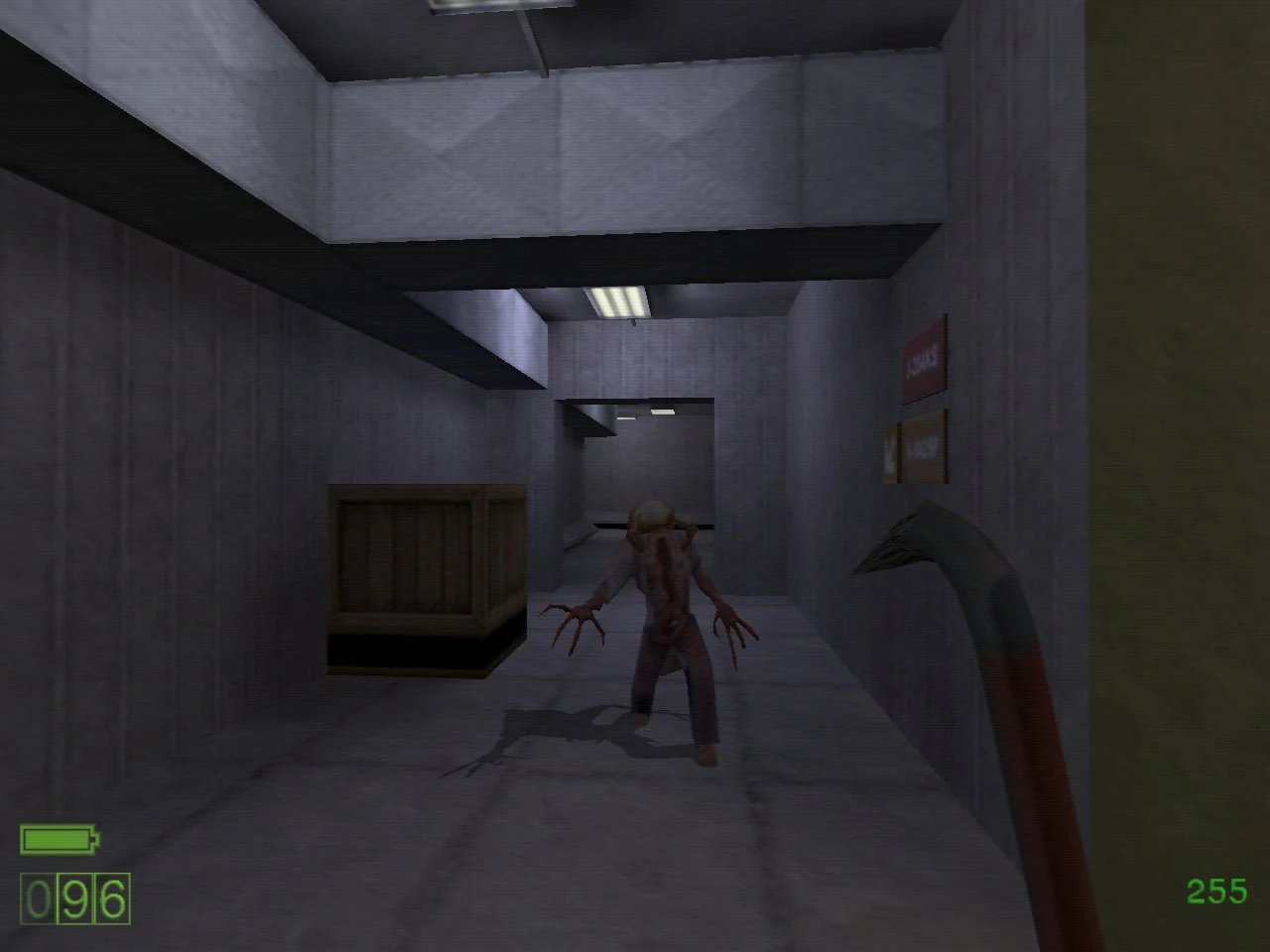 First-person view of Half-Life with an alien creature approaching in a dim corridor holding a crowbar