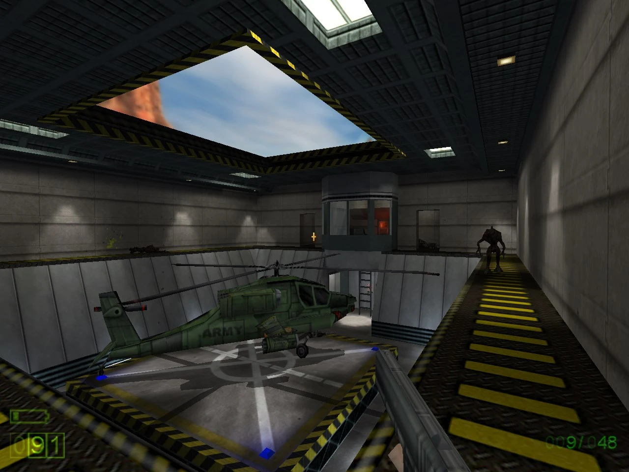 Interior scene in Half-Life Triphammer mod showing a green army helicopter and a player character holding a weapon
