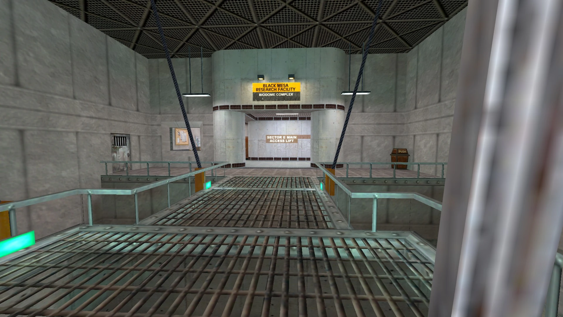 Metal walkway inside a concrete research facility with a yellow sign reading Black Mesa Research Facility