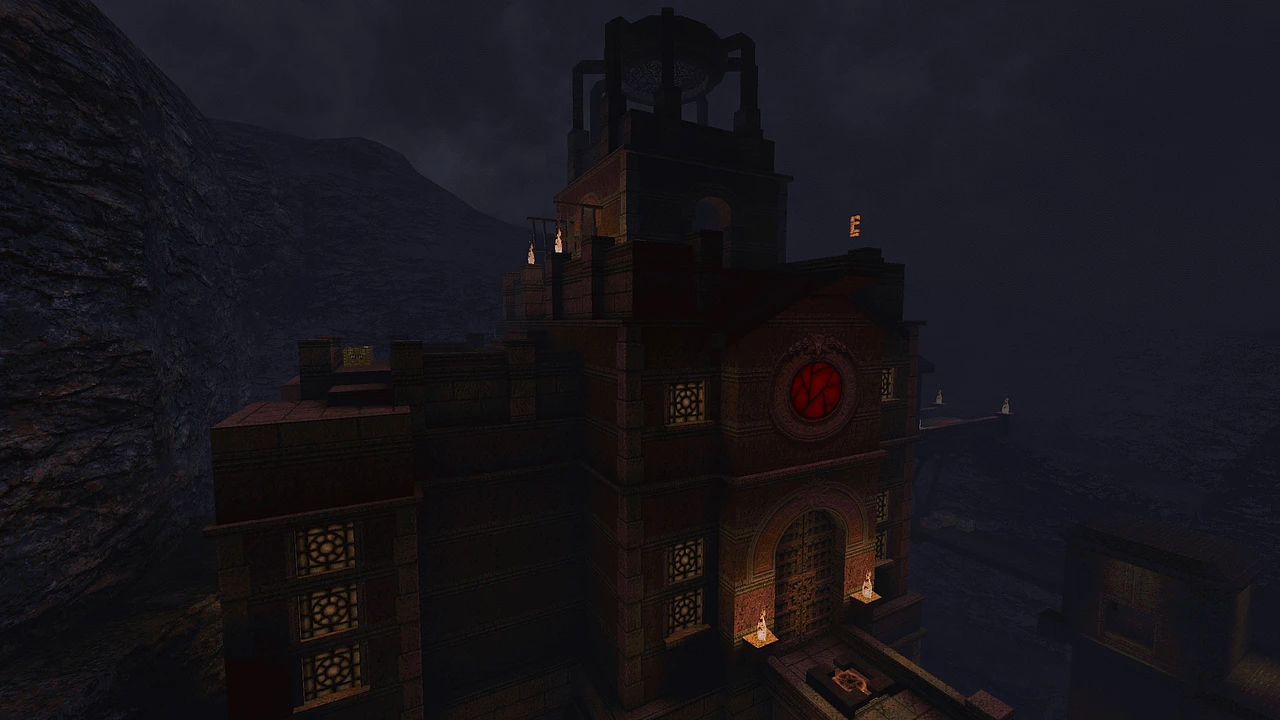 Ciemna twierdza z czerwonym świecącym okrągłym emblematem pod nocnym niebem w modzie Deathmatch Dimension do Quake