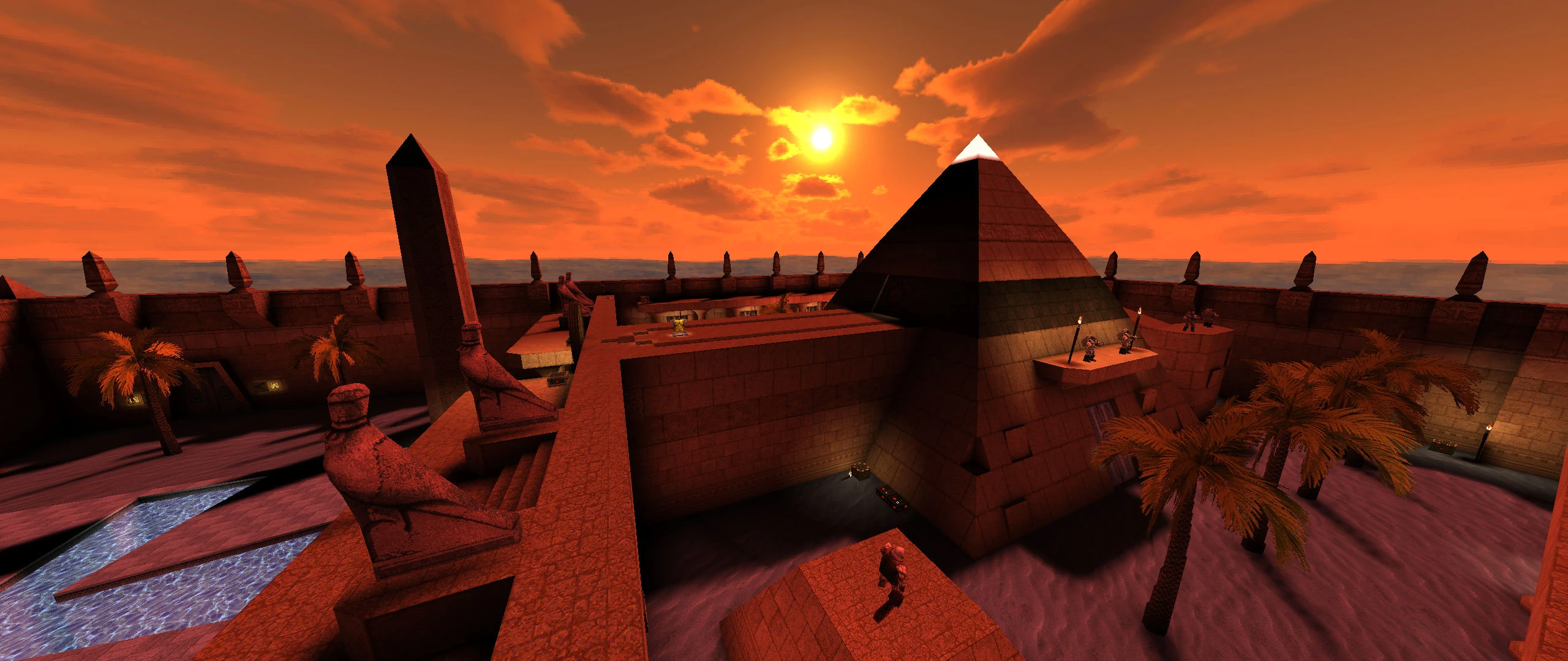 Vista al atardecer de una fortaleza desértica con una gran pirámide, palmeras y estatuas de piedra en el mod Quake Dwell
