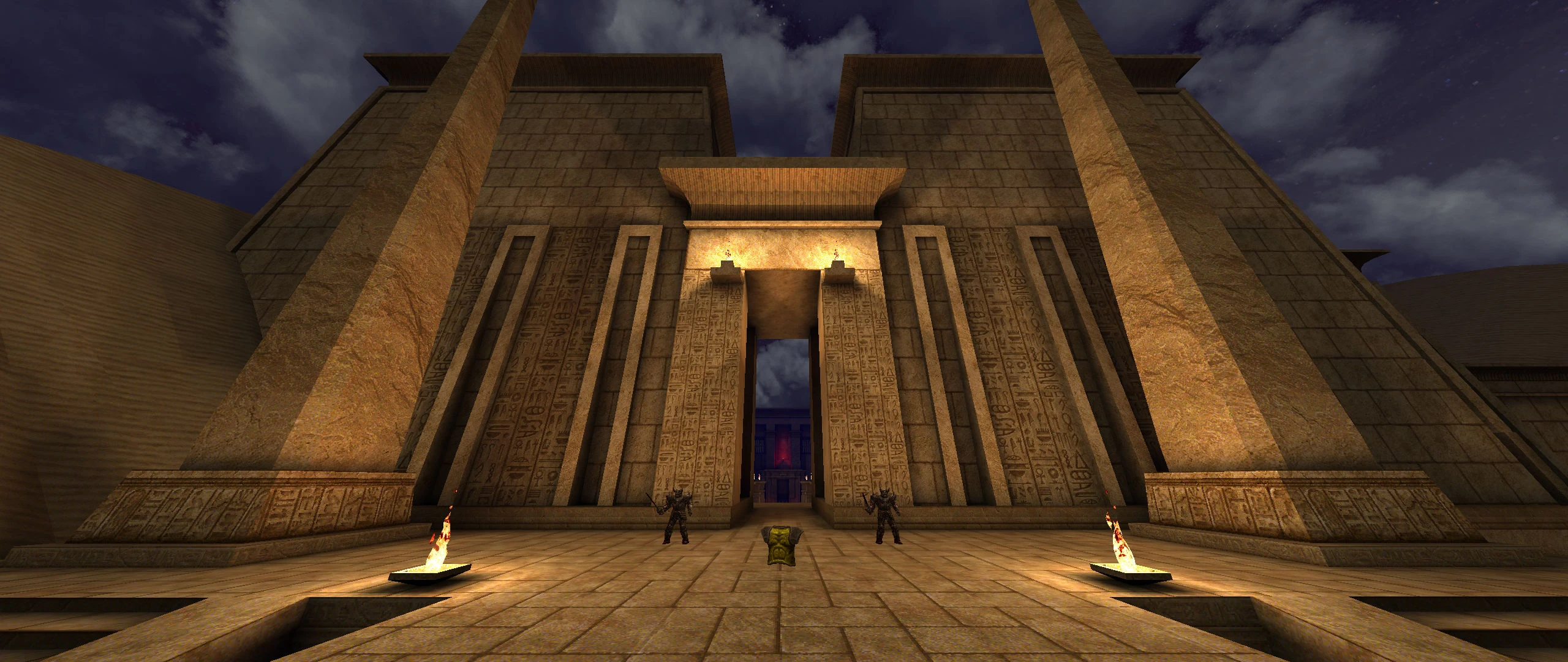 Escena nocturna de la entrada de un templo antiguo de piedra con jeroglíficos y dos figuras armadas en el mod Quake Dwell