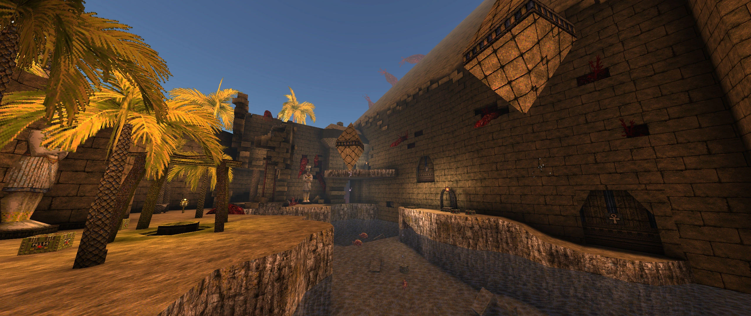 El mod Dwell de Quake muestra un patio egipcio antiguo con palmeras, canal de agua y estatuas de piedra
