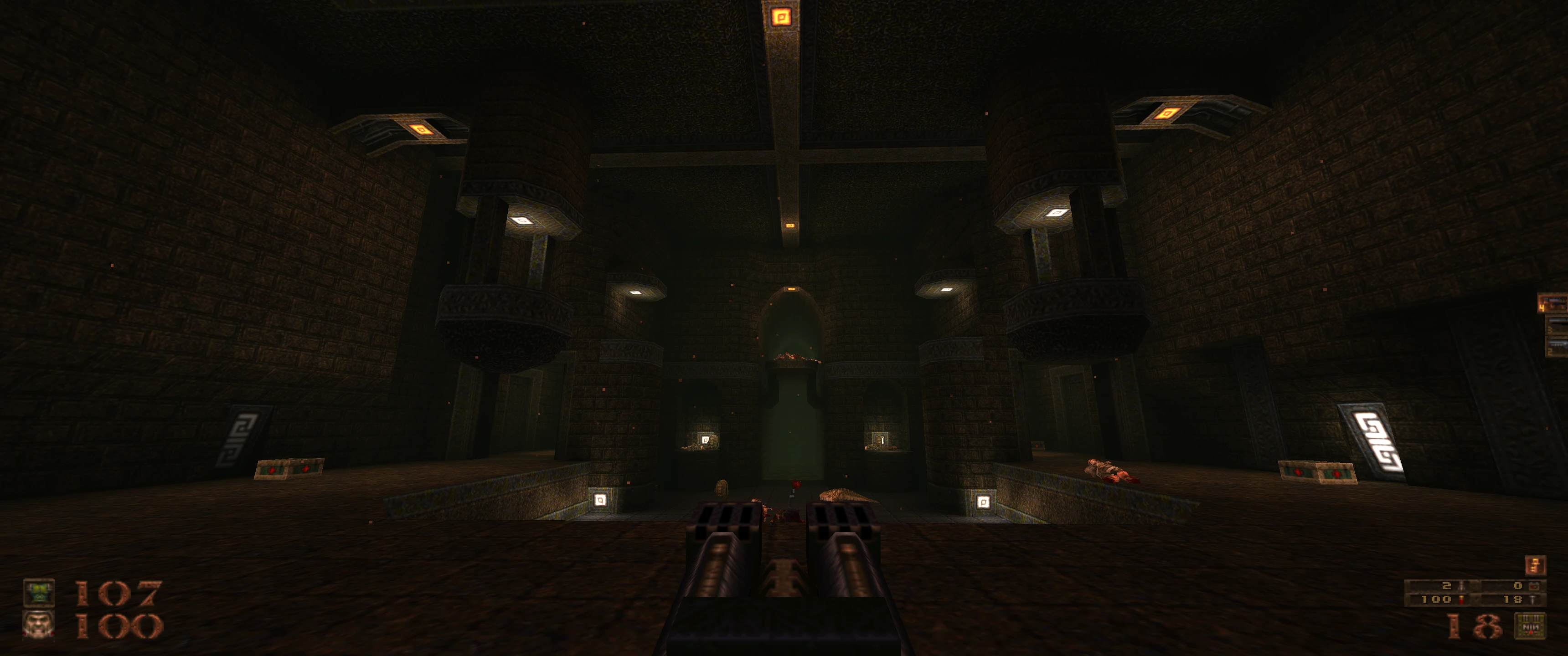 Vista en primera persona de una arena gótica oscura con miniguns dobles listas en el mod Quake Dwell