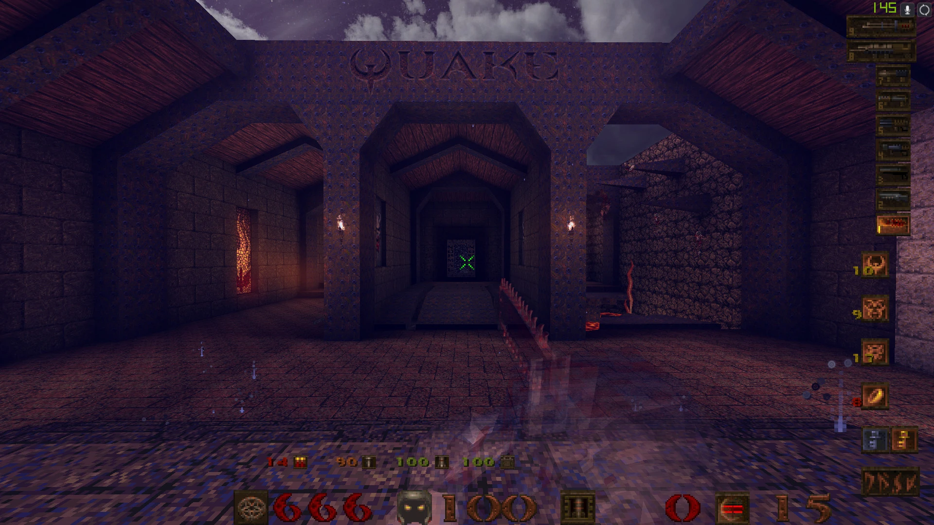 Erste-Person-Ansicht eines dunklen Burggangs mit Quake-Logo an der Wand und sichtbarem Spiel-HUD