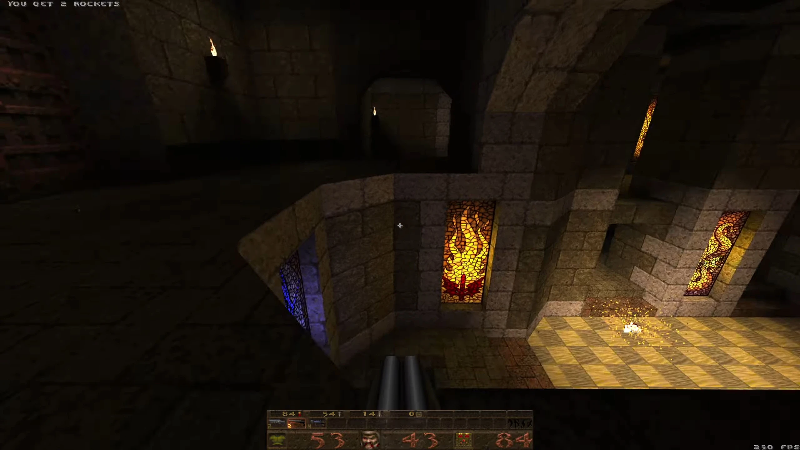 Скріншот моду Quake Realm of Dissonance з темними кам'яними коридорами та вітражним вікном
