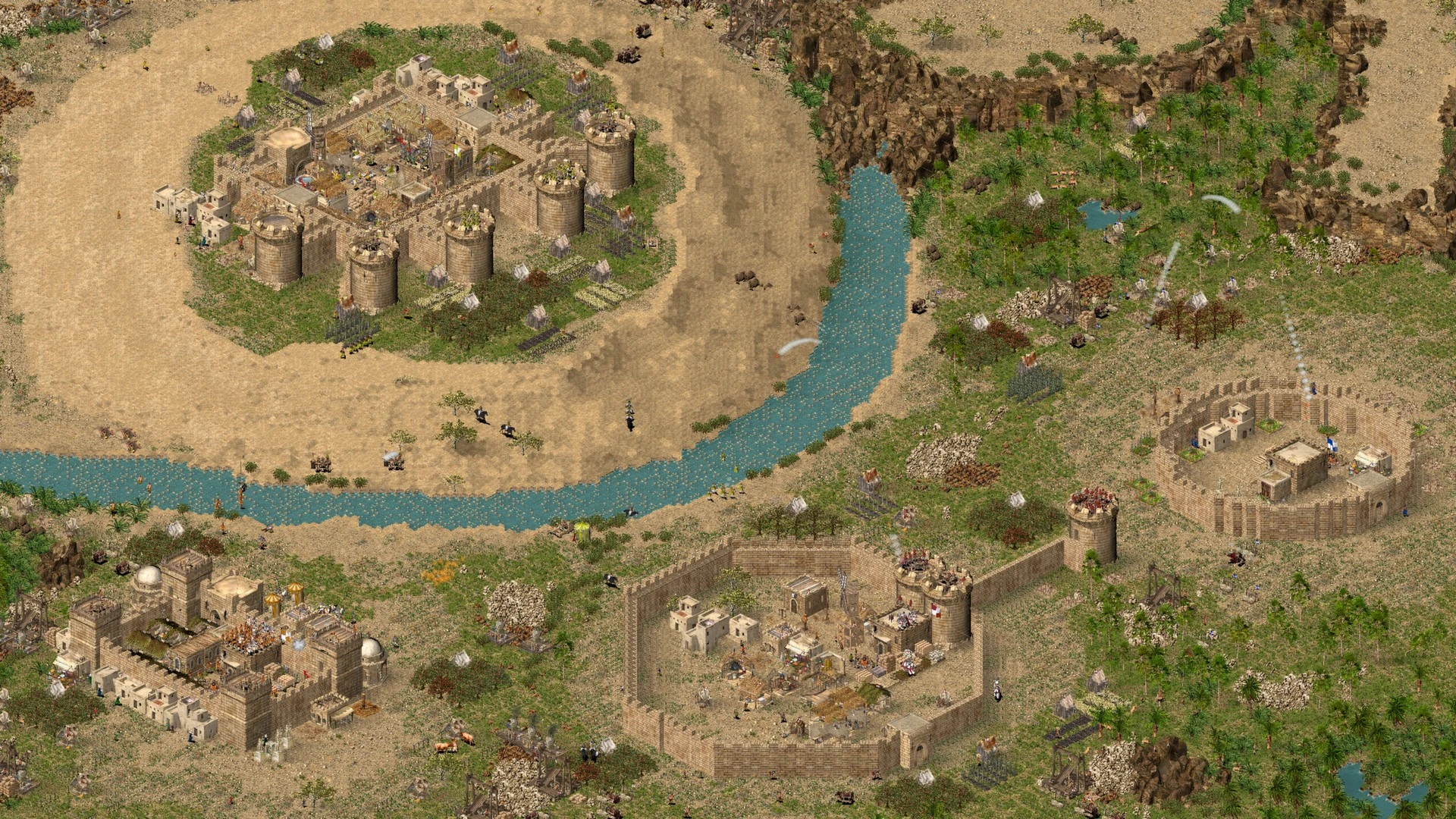 Screenshot aus Stronghold Crusader mit einer kleinen Wüstensiedlung an einer Flussbiegung
